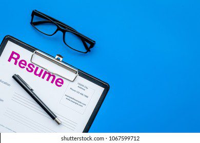 Glass and resume questionnaire with pen